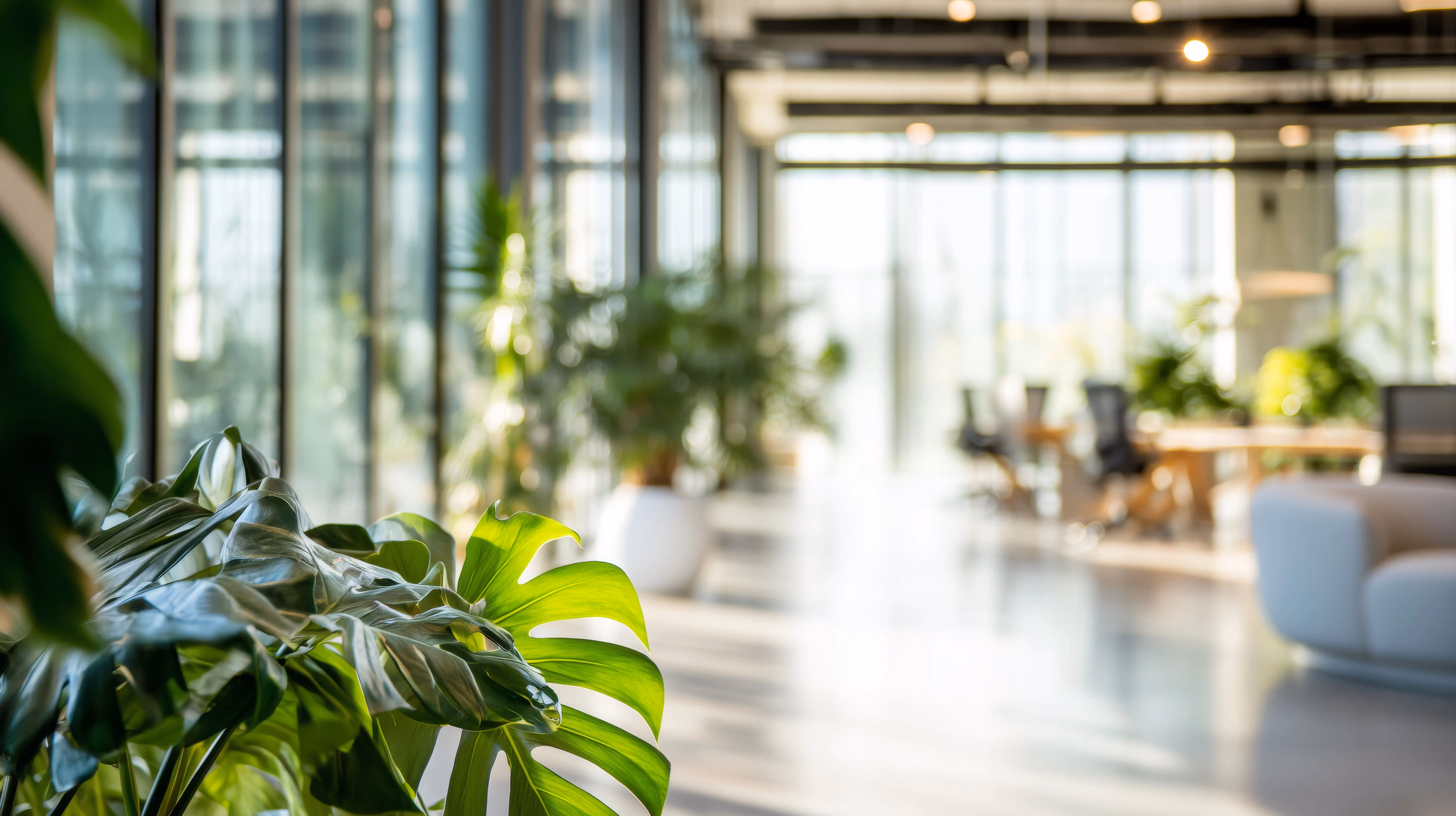 Professional business and engineering team collaborating in an open-office environment.